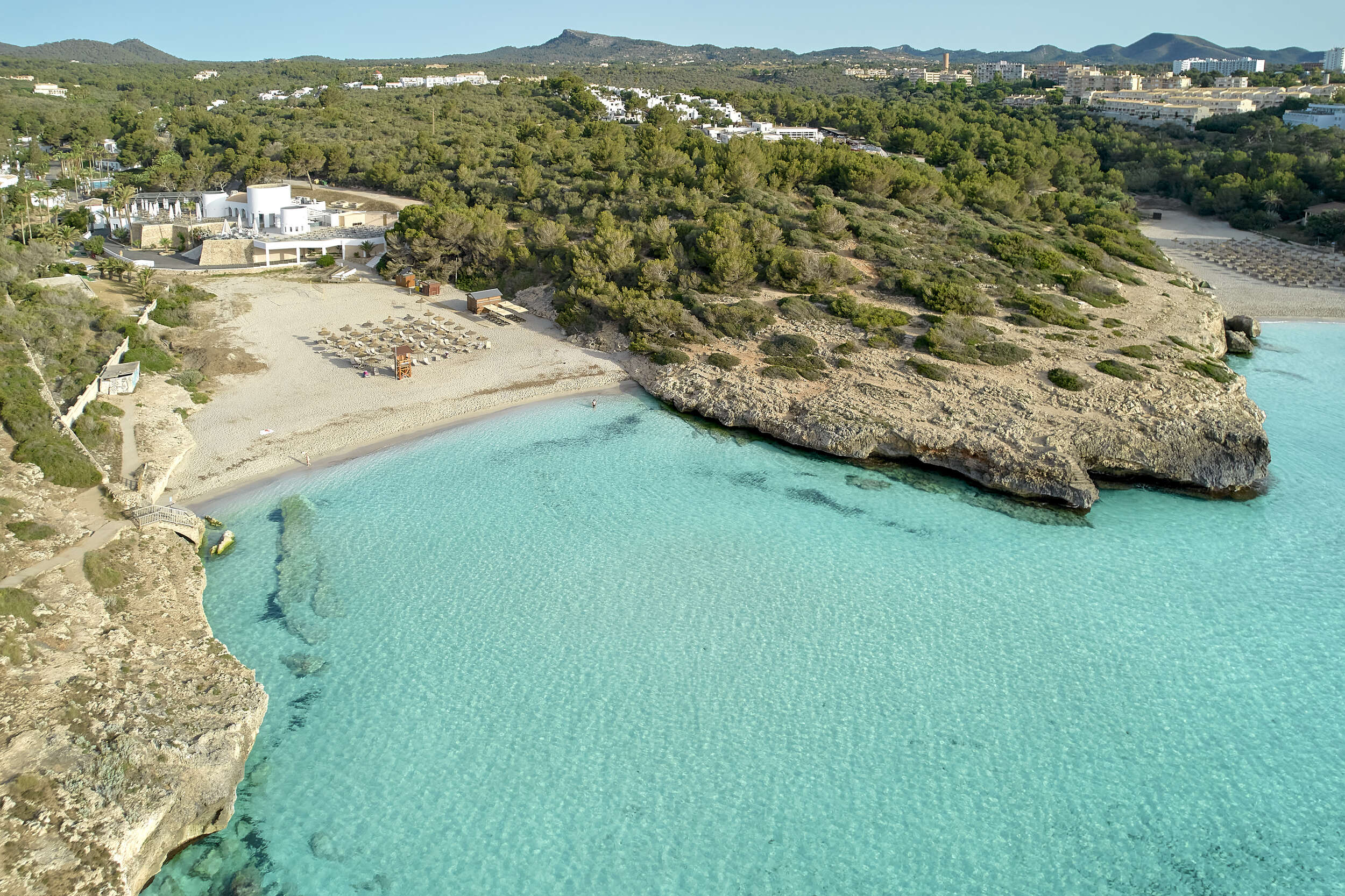 Aerial View of Secluded Beach with Clear Blue Water