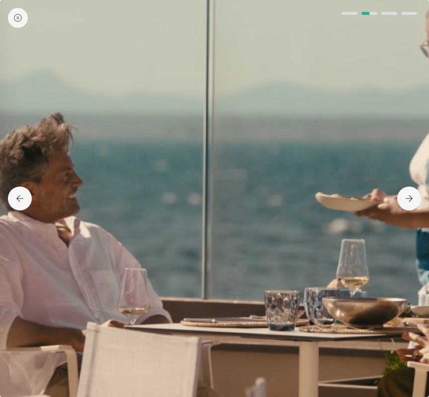 Outdoor dining scene with ocean view and tableware