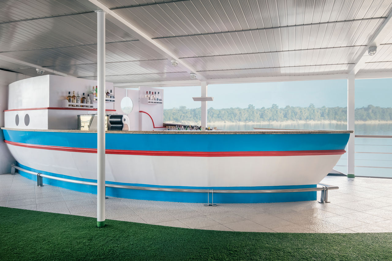 Boat-shaped outdoor bar on covered terrace